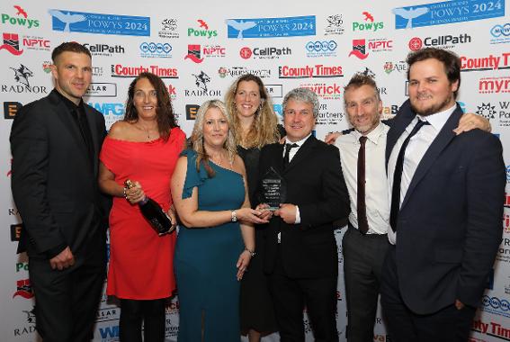 A group of people accepting an award